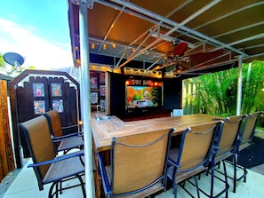 Enjoy the islands best daytime work desk by day & TIKI Bar with TV by night