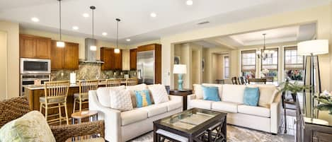 The living area of this Holua Kai at Keauhou rental, with two couches and a glass-topped coffee table.