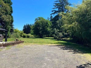 Gravel parking area that opens up to back yard