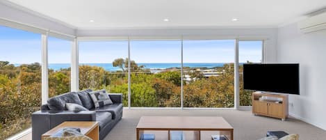 Upstairs, relax in the living room with a flat-screen TV and split-system air-conditioning. You'll also find impressive floor-to-ceiling glass panels that give you refreshing views of lush coastal forest and stunning views of the ocean's pristine azure wa