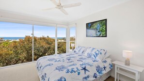 Bedroom 1: Queen bed, a built-in robe, and a study desk