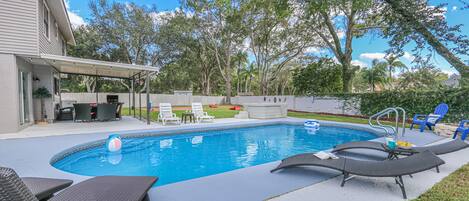 Enjoy a relaxing day poolside in the large private backyard