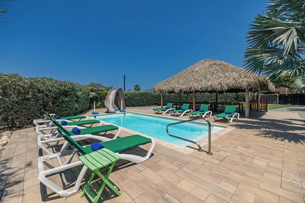 Unwind in paradise! Our sparkling pool is surrounded by comfortable sun loungers, inviting you to relax, soak up the sun, and enjoy the tropical breeze
