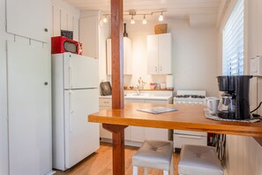 Cute kitchen, with unique bar top and all your kitchen essentials equipped.