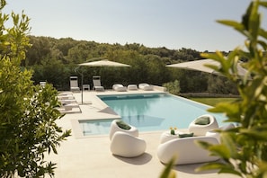 View of the outdoor terrace with sunbeds next to the private pool in the Croatia luxury villa for family vacations
