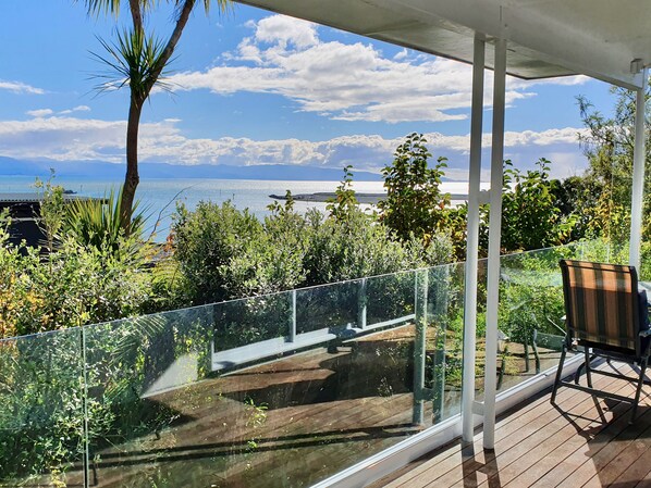 Sunny balcony with sea views - over mature trees to Nelson's harbour entrance!
