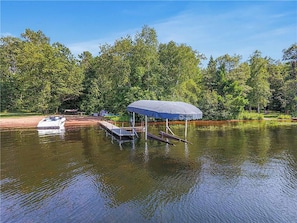 Enjoy your own private dock and sandy beach out front at Bayshore Retreat
