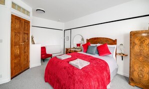Bedroom: Vibrant red accents enhance this inviting retreat, perfect for restful nights in style!