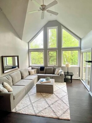 Beautifully updated living room! New giant sectional, rug and floors.