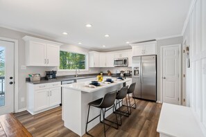 Fully stocked kitchen with island seating for 3.
