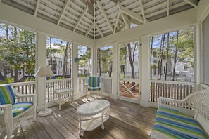 SPACIOUS BACK PORCH WITH CUSHIONED OUTDOOR SEATING