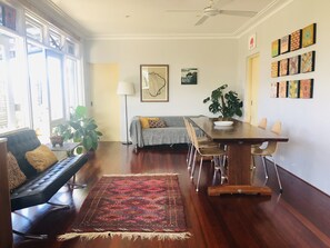 Dinning area connects kitchen to living space, double doors lead to balcony 