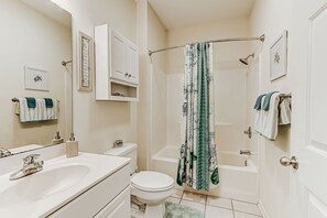 Mini Suite Bathroom has tub-shower combo with curved rod for elbow room