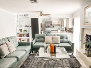 Comfy living room opens to kitchen and pool 