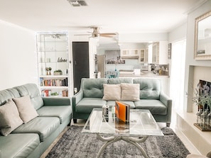 Comfy living room opens to kitchen and pool 