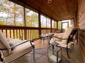 Screened in deck off master bedroom is a fantastic spot to listen to birds and enjoy the wooded view.