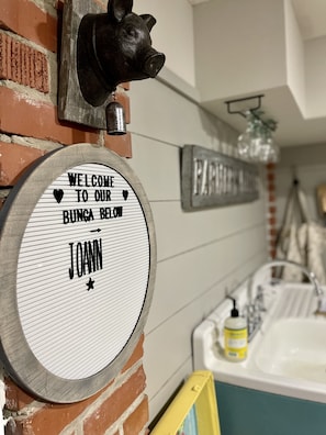 Welcome. Charming decor awaits you…like pigs and shiplap and stuff.