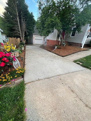 Walk down the driveway and entrance is immediately to the right UNDER the deck.