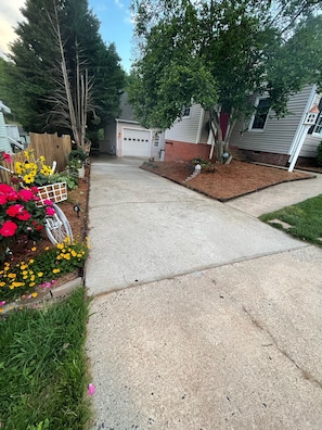 Walk down the driveway and entrance is immediately to the right UNDER the deck. 