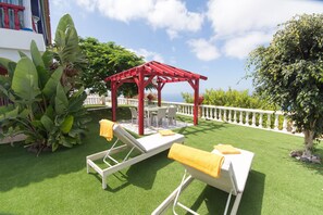 Sun loungers on terrace with sea views