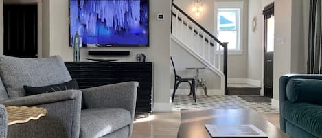 Sun drenched living room with 55" smart TV with Samsung Plus TV and Sonos.