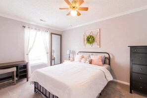 1st guest room has a queen bed and desk/bench