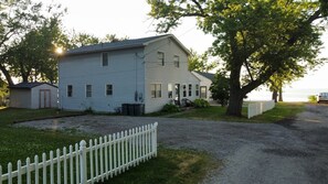 Large driveway accommodates up to six cars with additional parking for four on the road.