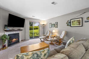 Comfortable living area with sofa bed, Cable TV, and Patio Access.