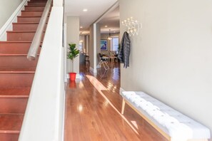 The beautiful foyer with a hall bench and coat hooks