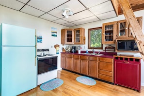 Fully-stocked kitchen with a stove/oven and microwave