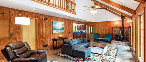 Enjoy the spacious living room with high ceilings and wood stove.  Perfect for gathering with friends and family!