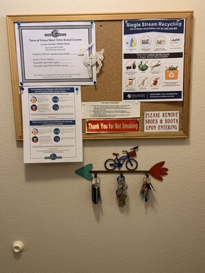 Notices, license and key rack inside front door.