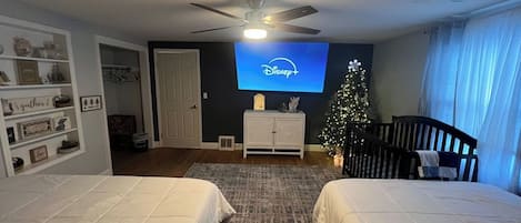 75 inch tv with king and queen beds for sleeping arrangements.