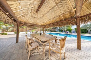 Dine al fresco by the shimmering pool, where every gathering becomes a cherished memory.