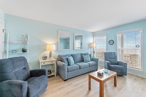 Bright living area with patio leading to the beach