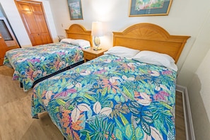 - Cozy, tropical themed double room with vibrant floral bedding - Features two comfortable full size beds, perfect for families or friends traveling together - Bright, beachy vibes paired with wooden furnishings & soft ambient lighting for a relaxed stay