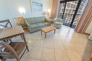 - Open living space is perfect for kicking back after a day in the sun - Features a comfy sofa, playful accent chair, & cozy dining nook for meals or games - Slide open the doors to your balcony & let in the ocean breeze, it’s beach living at its best