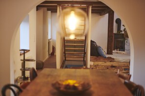 view from the dining room table looking at the stairs down to the exit of loft