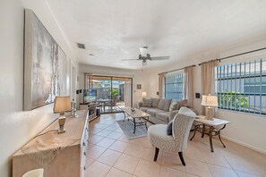 PV129 - Living with comfortable seating and flat screen TV. Sliding doors open to the screened in lanai and patio