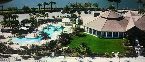 Resort pool and Tiki bar and restaurant with views of lake. 