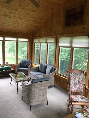 Sun room with screened windows to enjoy summer breezes