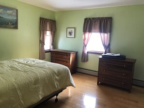 Master bedroom with matching walnut bureaus