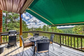 The shaded patio is your perfect retreat, featuring tables and chairs with beautiful nature views, offering comfort and tranquility.