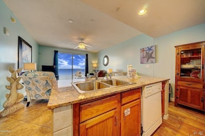 Kitchen with granite countertops, double sink with garbage disposal & dishwasher