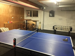 Downstairs garage with table tennis, dart board, fuseball and bar table. 