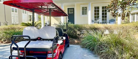 Brand new beautiful red Icon 6 passenger golf cart for guest use.