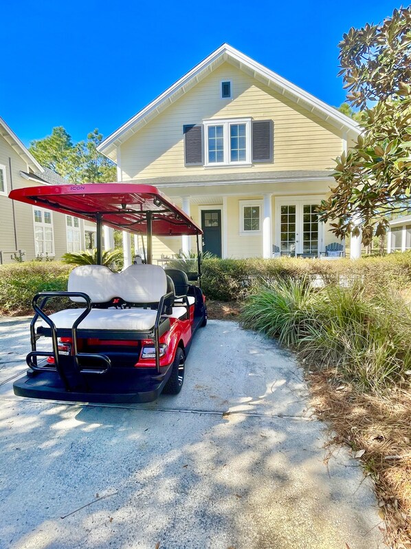 Brand new beautiful red Icon 6 passenger golf cart for guest use.