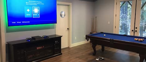 Game room with 82 inch tv, pool table and PS4 with plus subscription.