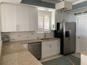 Plenty of counter space. Kitchen window has view of beach looking west
