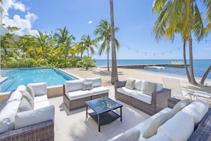 Lounge by the seaside along the villa's beachfront patio. 